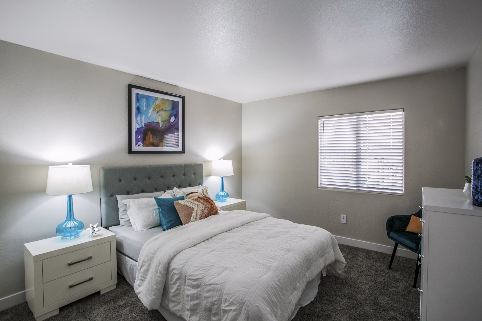 Modern bedroom with plush bedding and natural light at Villas at 6300 Apartments