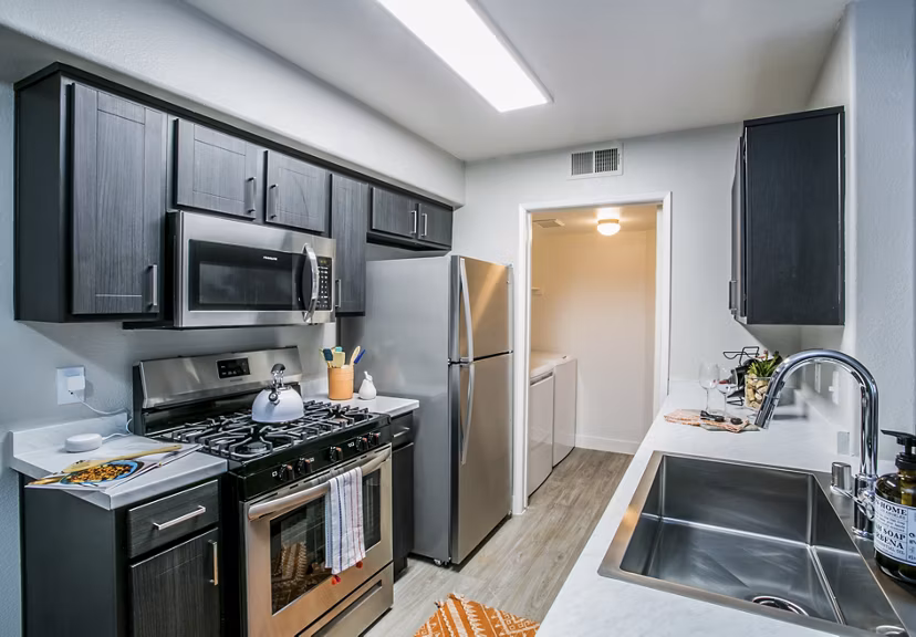 Modern kitchen with stainless steel appliances at Villas at 6300 Apartments