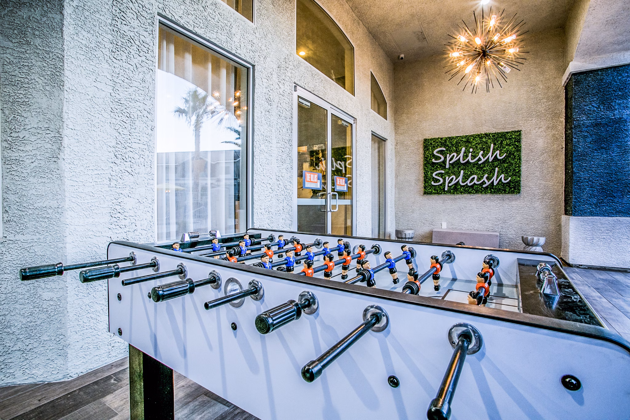 Game area with outdoor seating on patio at Villas at 6300 Apartments