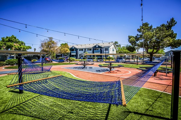 hammock and picnic table area at Villas at 6300 Apartments