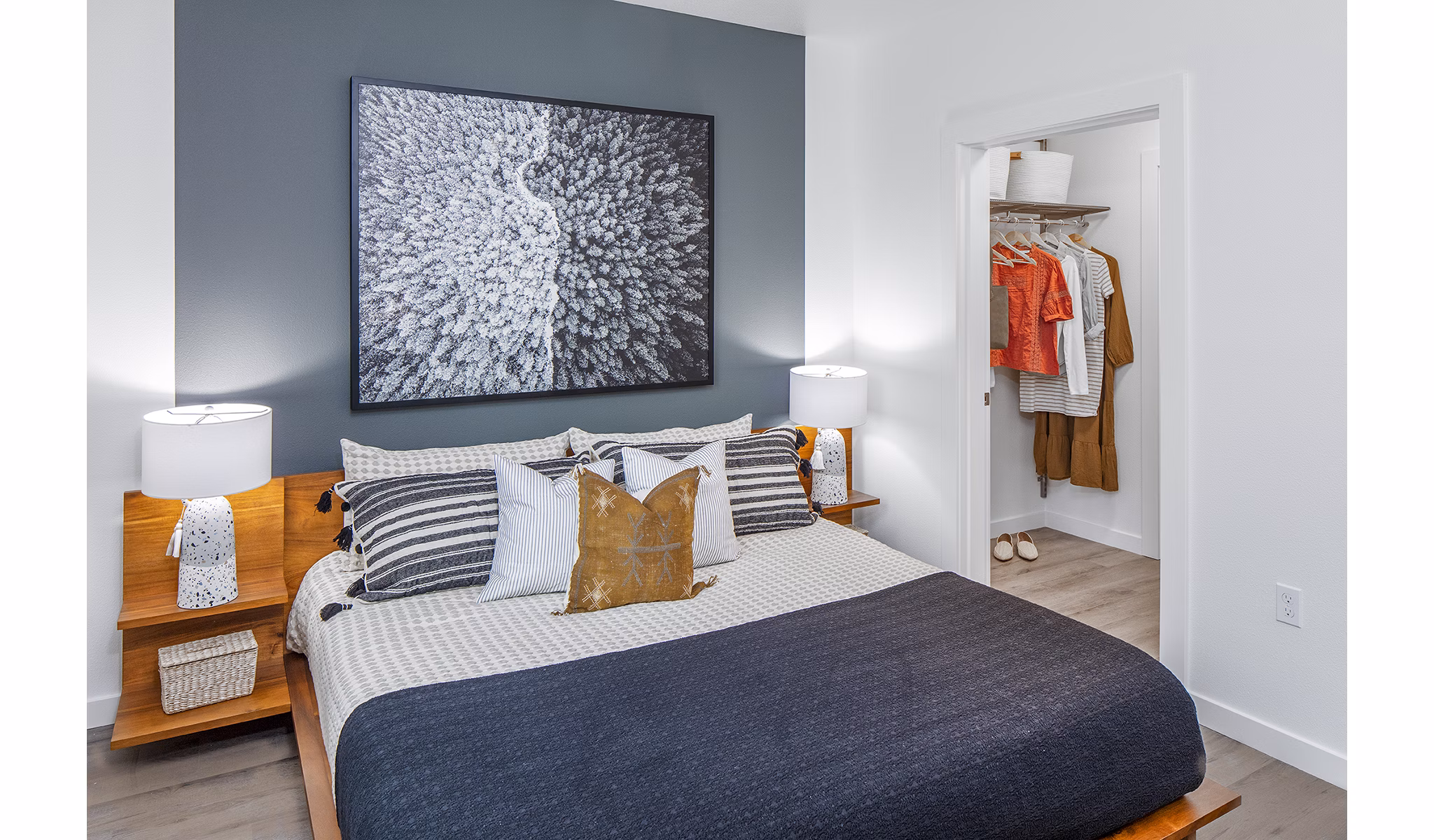 Modern bedroom featuring elegant decor and large windows at Mercato Grove Apartments