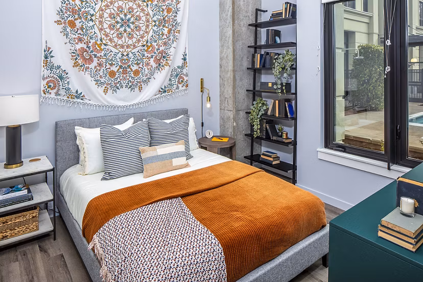 Cozy bedroom with modern decor at Mercato Grove Apartments