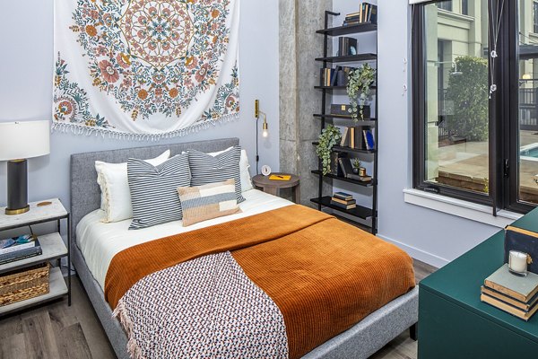 Cozy bedroom with modern decor at Mercato Grove Apartments