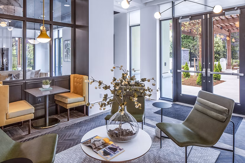 Clubhouse lobby with chic design and cozy seating at Mercato Grove Apartments