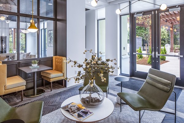 Clubhouse lobby with chic design and cozy seating at Mercato Grove Apartments
