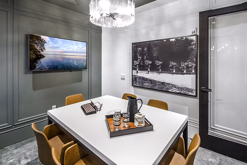 Modern clubhouse with meeting room at Mercato Grove Apartments featuring stylish seating and large windows