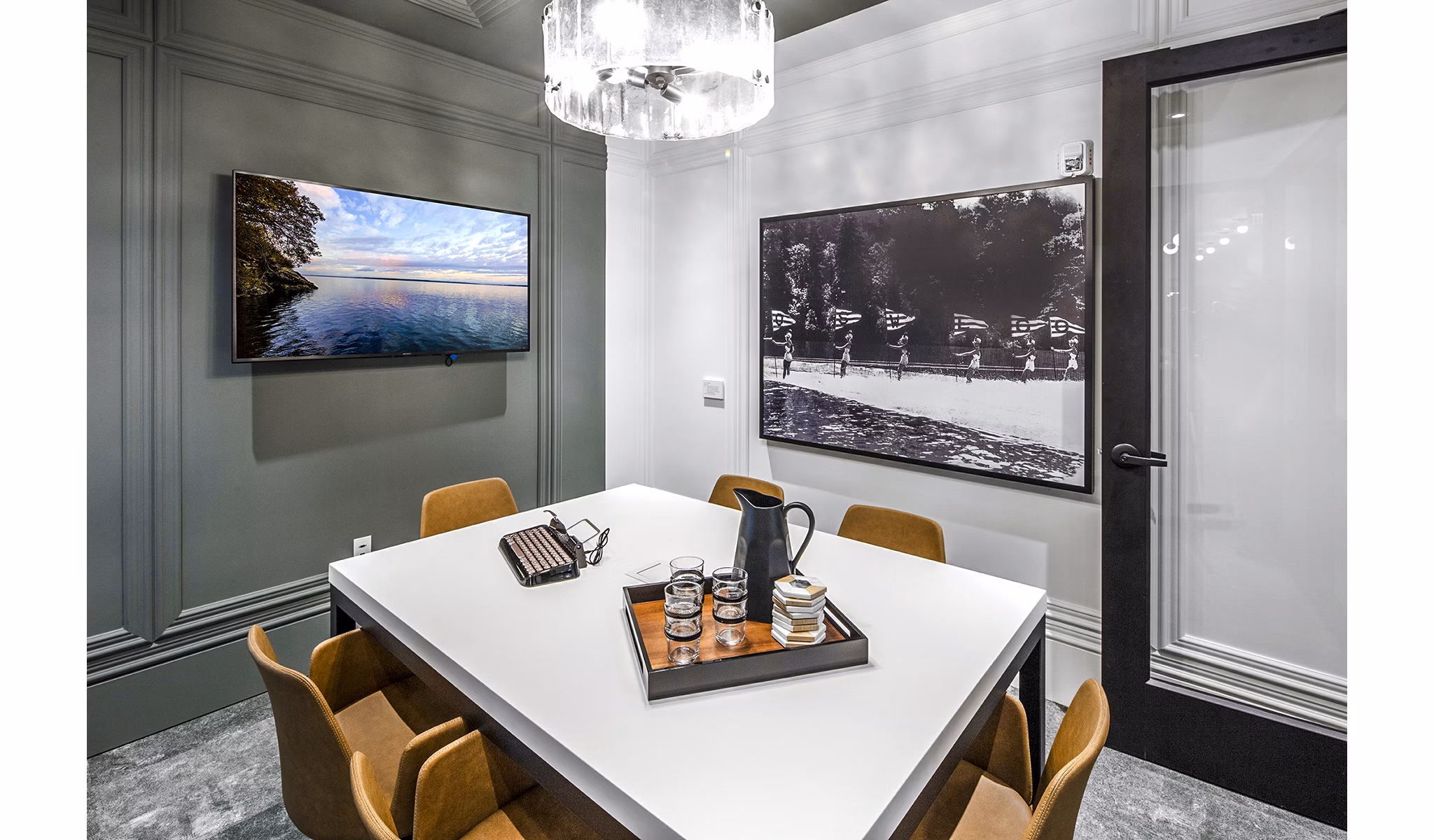 Modern clubhouse with meeting room at Mercato Grove Apartments featuring stylish seating and large windows