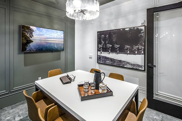 Modern clubhouse with meeting room at Mercato Grove Apartments featuring stylish seating and large windows