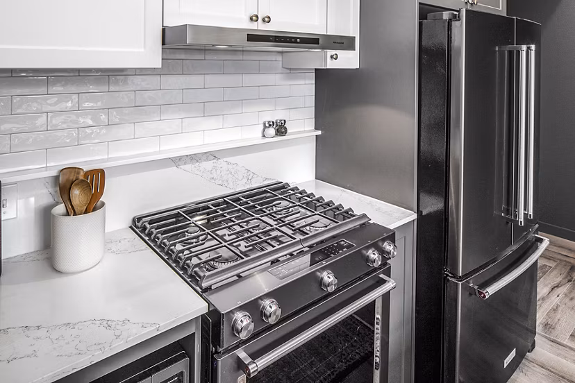Modern kitchen with stainless steel appliances at Mercato Grove Apartments, a Greystar luxury community
