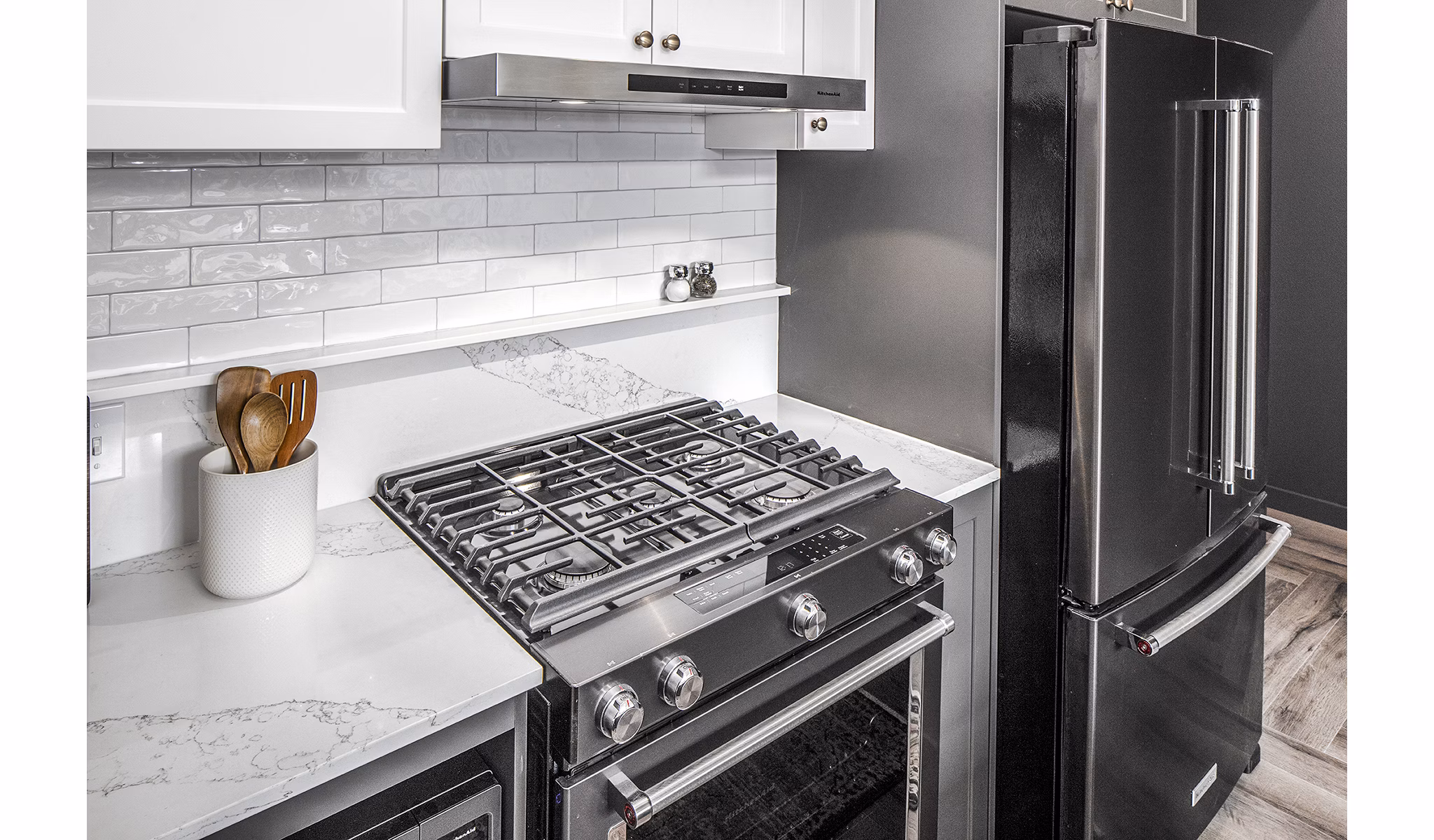 Modern kitchen with stainless steel appliances at Mercato Grove Apartments, a Greystar luxury community
