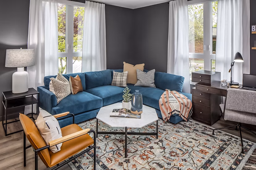 Welcoming living room with modern decor and large windows at Mercato Grove Apartments