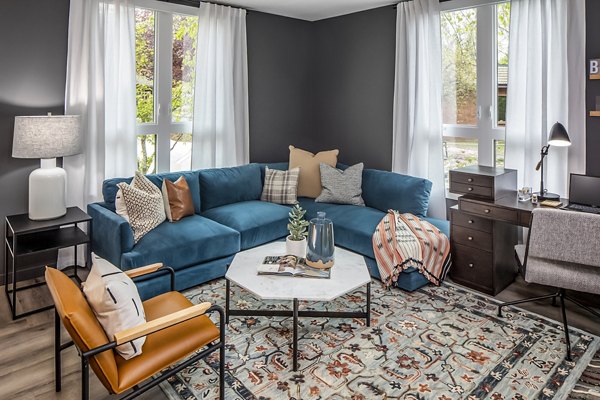 Welcoming living room with modern decor and large windows at Mercato Grove Apartments