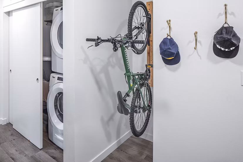 Laundry room with modern appliances and bike storage at Mercato Grove Apartments in urban setting