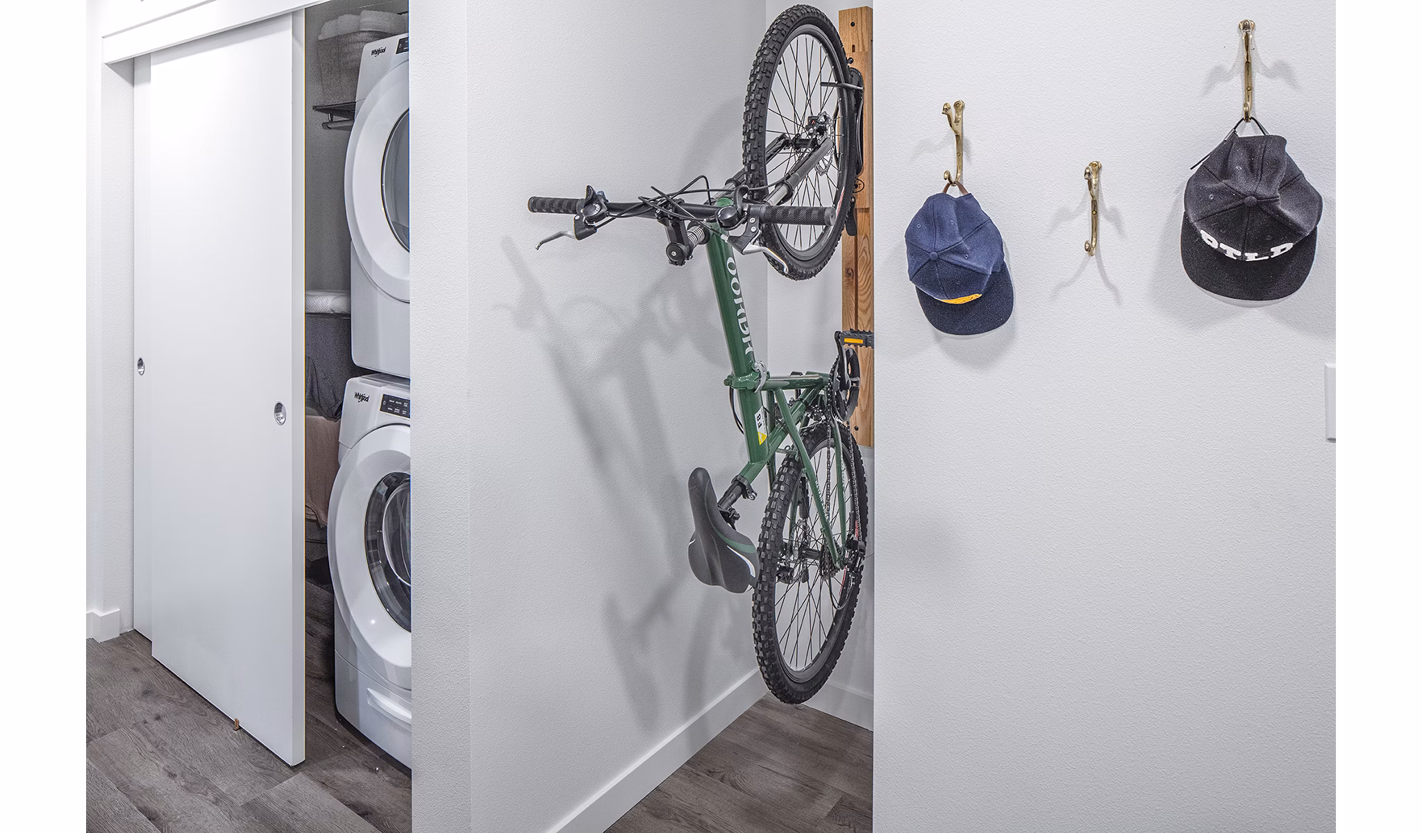 Laundry room with modern appliances and bike storage at Mercato Grove Apartments in urban setting