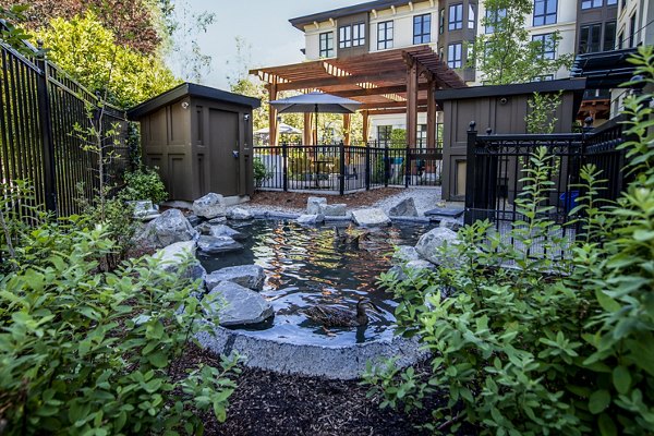 Courtyard with modern seating and lush greenery at Mercato Grove Apartments, a Greystar luxury apartment community