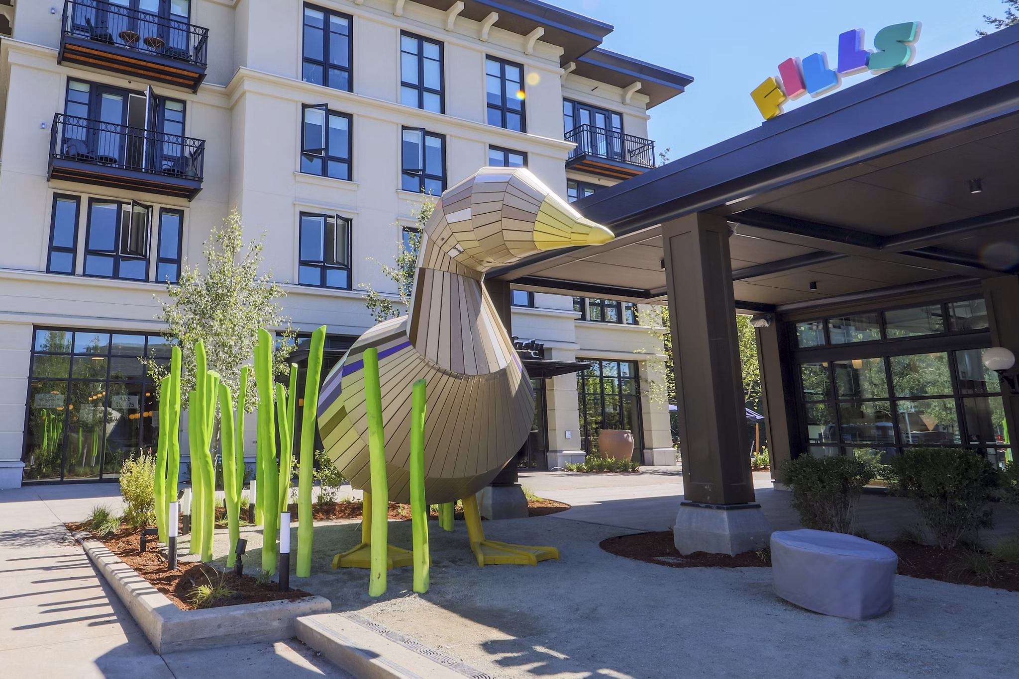 Courtyard featuring lush landscaping and outdoor seating at Mercato Grove Apartments in Italy, Oregon
