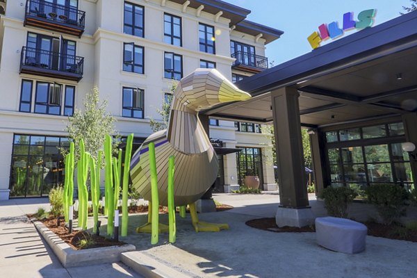 Courtyard featuring lush landscaping and outdoor seating at Mercato Grove Apartments in Italy, Oregon
