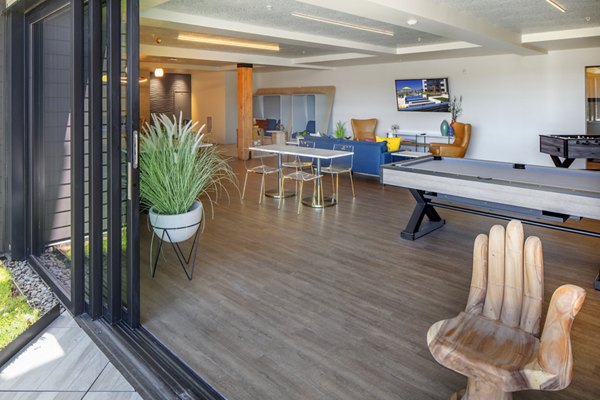 Modern game room featuring billiards and lounges at Aria Apartments