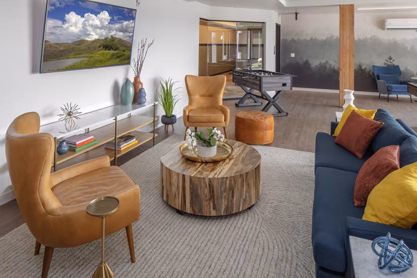 Game room with billiards table and modern seating at Aria Apartments