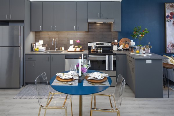 Dining area with modern furnishings and natural lighting in Aria Apartments, offering luxury living