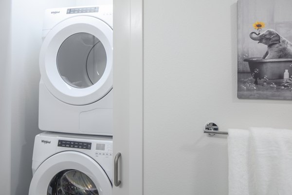 Laundry room with energy-efficient washers and dryers in Aria Apartments luxury community