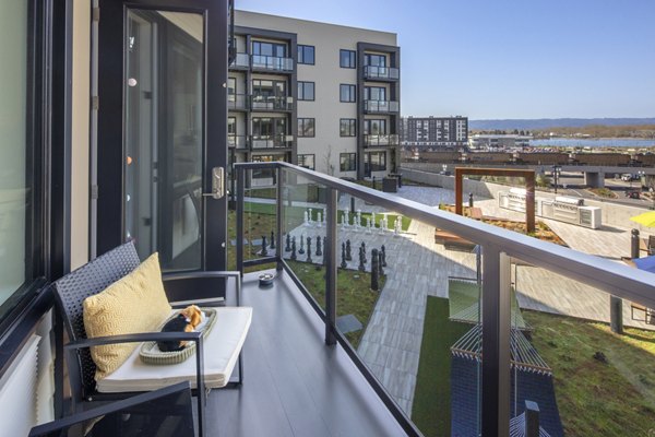 Outdoor patio with modern seating at Aria Apartments, featuring comfortable furniture and lush landscaping