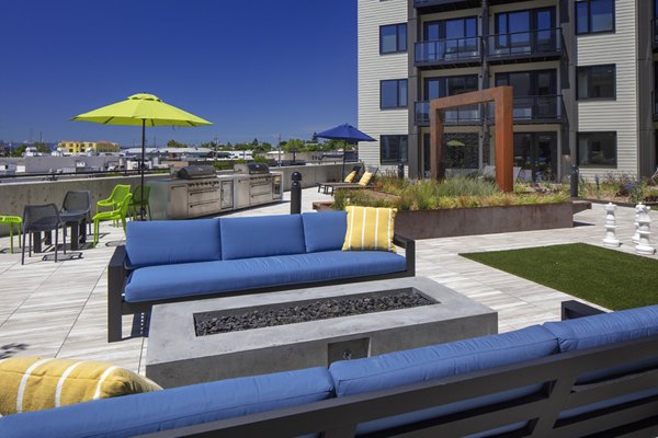 Fire pit area with seating at Aria Apartments, a luxury residence ideal for evening gatherings and relaxation