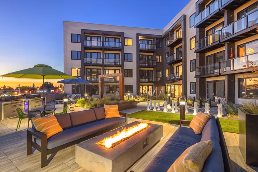 Cozy outdoor fire pit area at Aria Apartments, perfect for social gatherings and relaxation