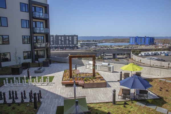 Scenic rooftop deck with city skyline views at Aria Apartments, perfect for relaxation and social gatherings in a luxurious setting