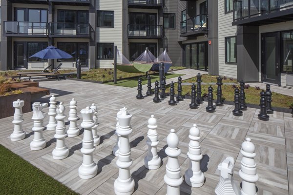 Sport court for basketball and tennis at Aria Apartments featuring modern surfaces and lighting