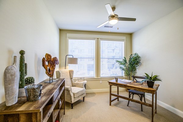 Cozy bedroom office with built-in desk and ample natural light at Everleigh Central Park Apartments