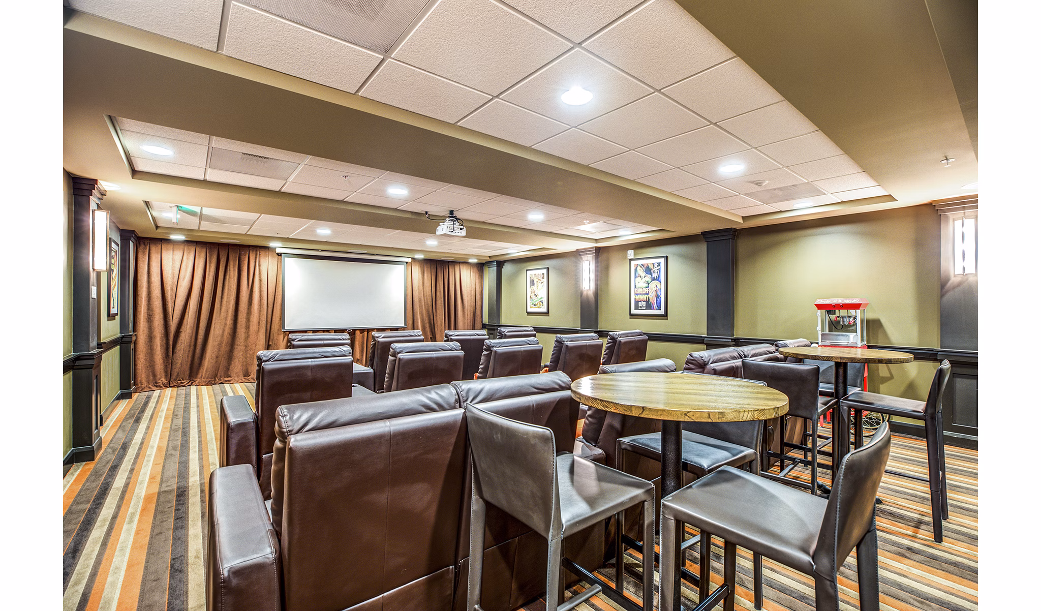 Clubhouse theater with plush seating at Everleigh Central Park Apartments providing entertainment space for residents
