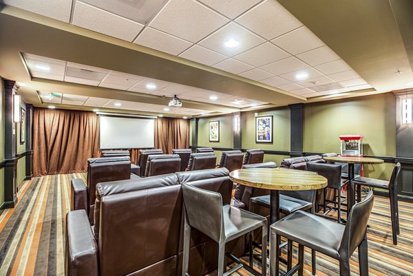Clubhouse theater with plush seating at Everleigh Central Park Apartments providing entertainment space for residents