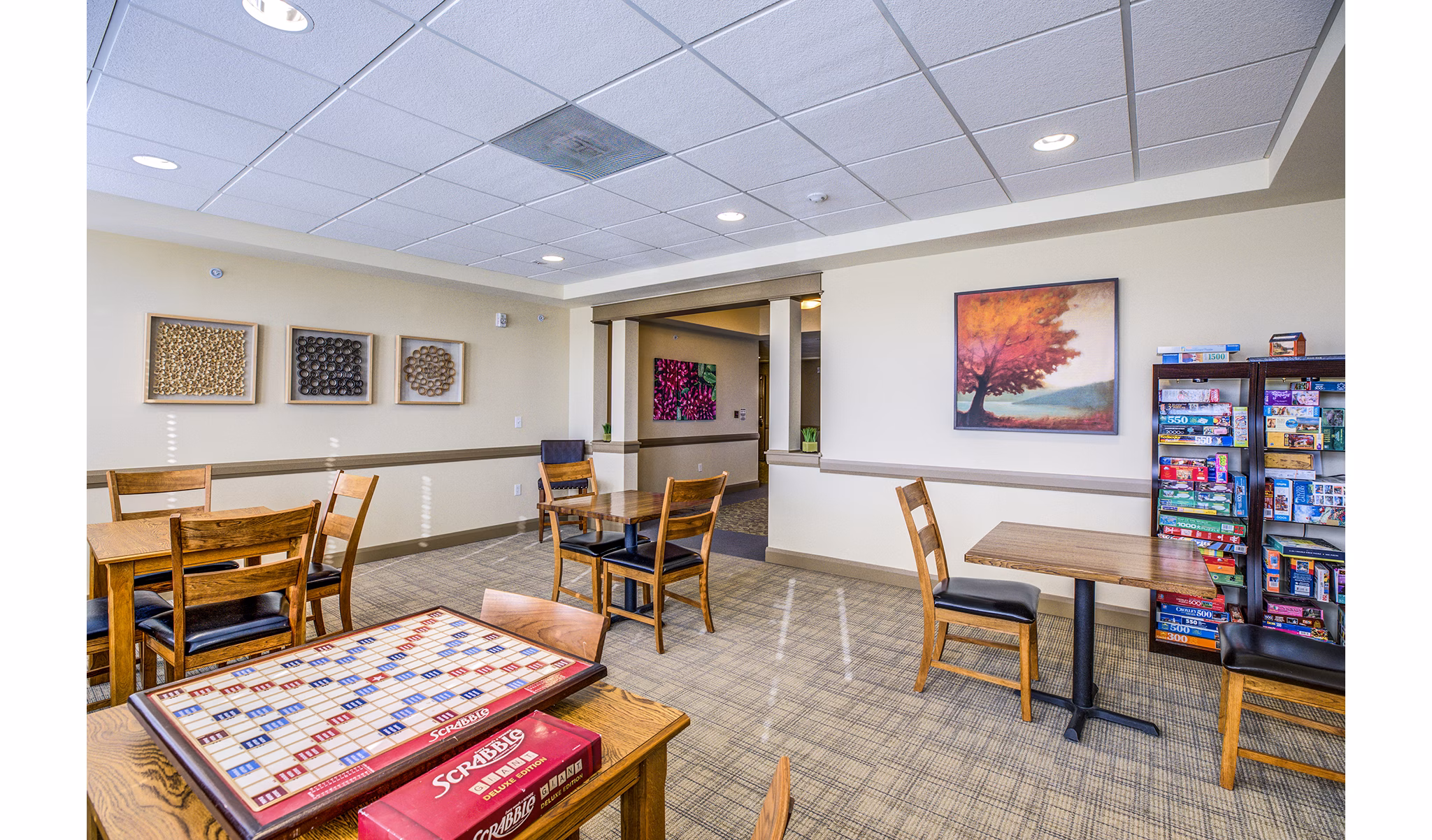 Clubhouse game room with billiards and lounge seating at Everleigh Central Park Apartments