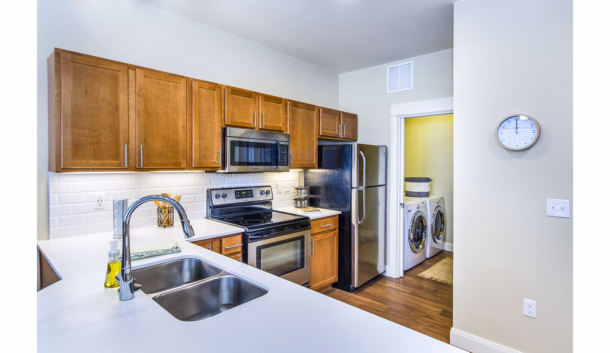Modern kitchen with stainless steel appliances at Everleigh Central Park Apartments