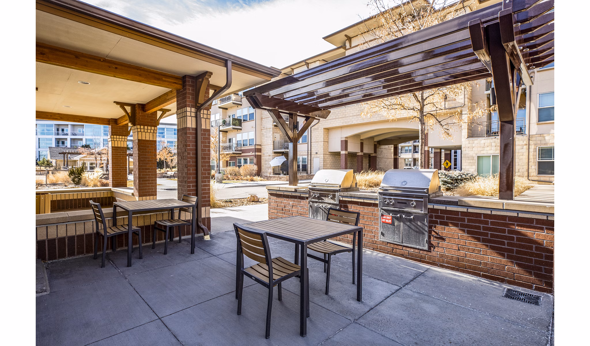 Grill area with modern barbecue stations at Everleigh Central Park Apartments for social gatherings and outdoor dining experiences