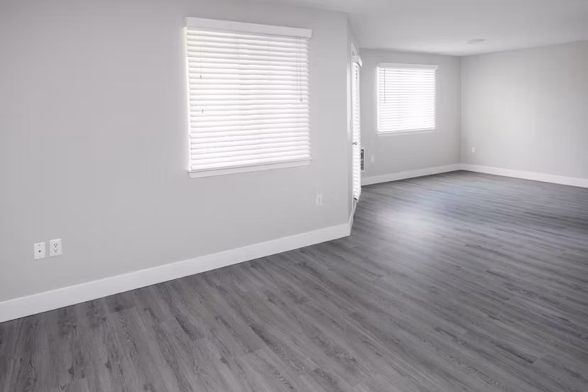 Living room with modern decor and large windows at Avana Evergreen Apartments