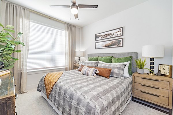 Elan Keller Ranch Apartments: Modern bedroom with plush bedding and ample natural light