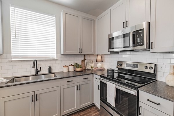 Modern kitchen with high-end appliances and sleek countertops at Elan Keller Ranch Apartments, offering luxury living near urban conveniences