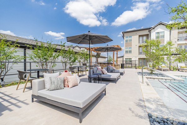 Resort-style pool with lounge seating at Elan Keller Ranch Apartments, luxury living in a serene setting