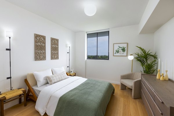 Modern bedroom with large windows in Biscayne 112 Apartments featuring luxurious design elements for a relaxing living experience