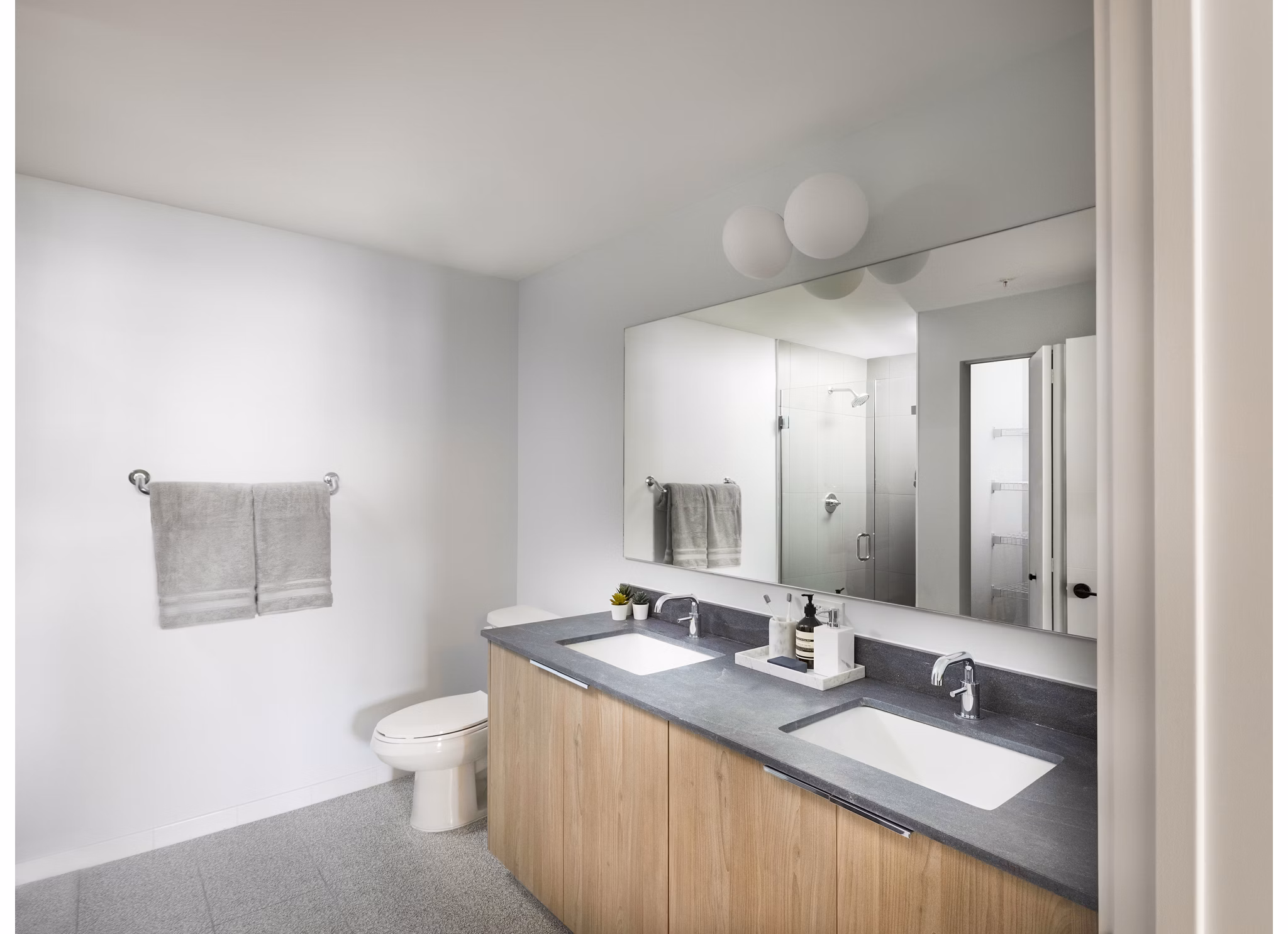 Modern bathroom with marble countertops and sleek fixtures at Biscayne 112 Apartments