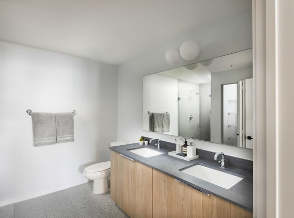 Modern bathroom with marble countertops and sleek fixtures at Biscayne 112 Apartments