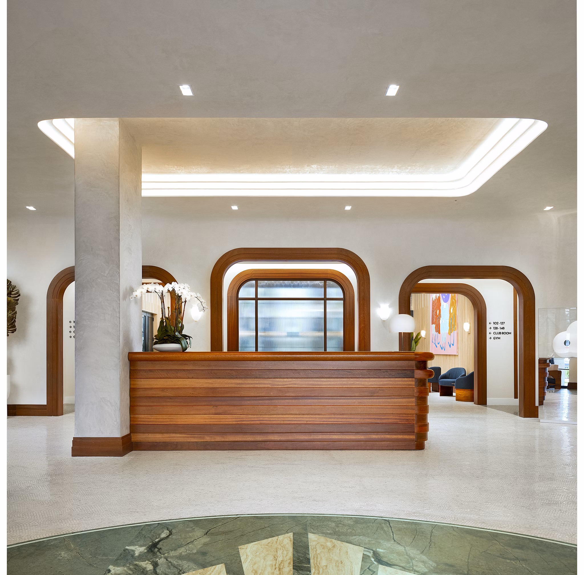 Clubhouse lobby with modern decor at Biscayne 112 Apartments featuring comfortable seating and elegant lighting
