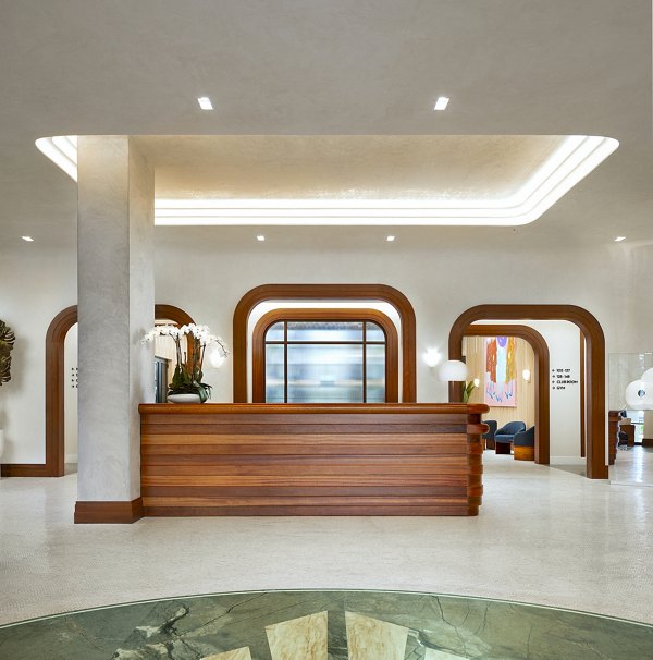 Clubhouse lobby with modern decor at Biscayne 112 Apartments featuring comfortable seating and elegant lighting