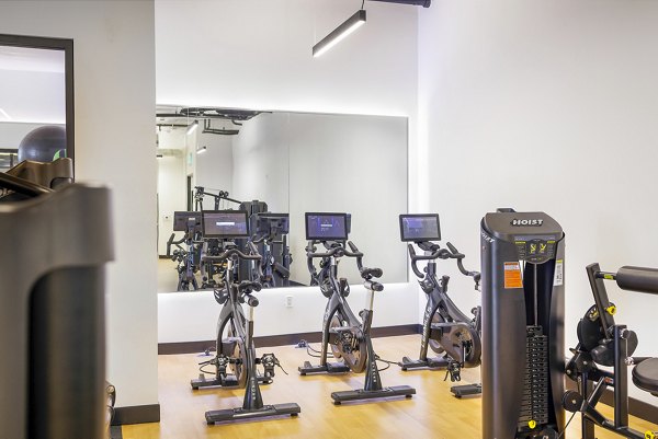 Spin studio featuring modern equipment at Biscayne 112 Apartments, a luxury living community by Greystar