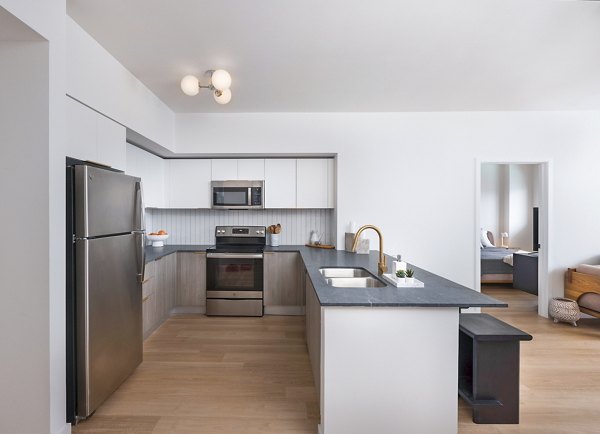 Modern kitchen with stainless steel appliances at Biscayne 112 Apartments