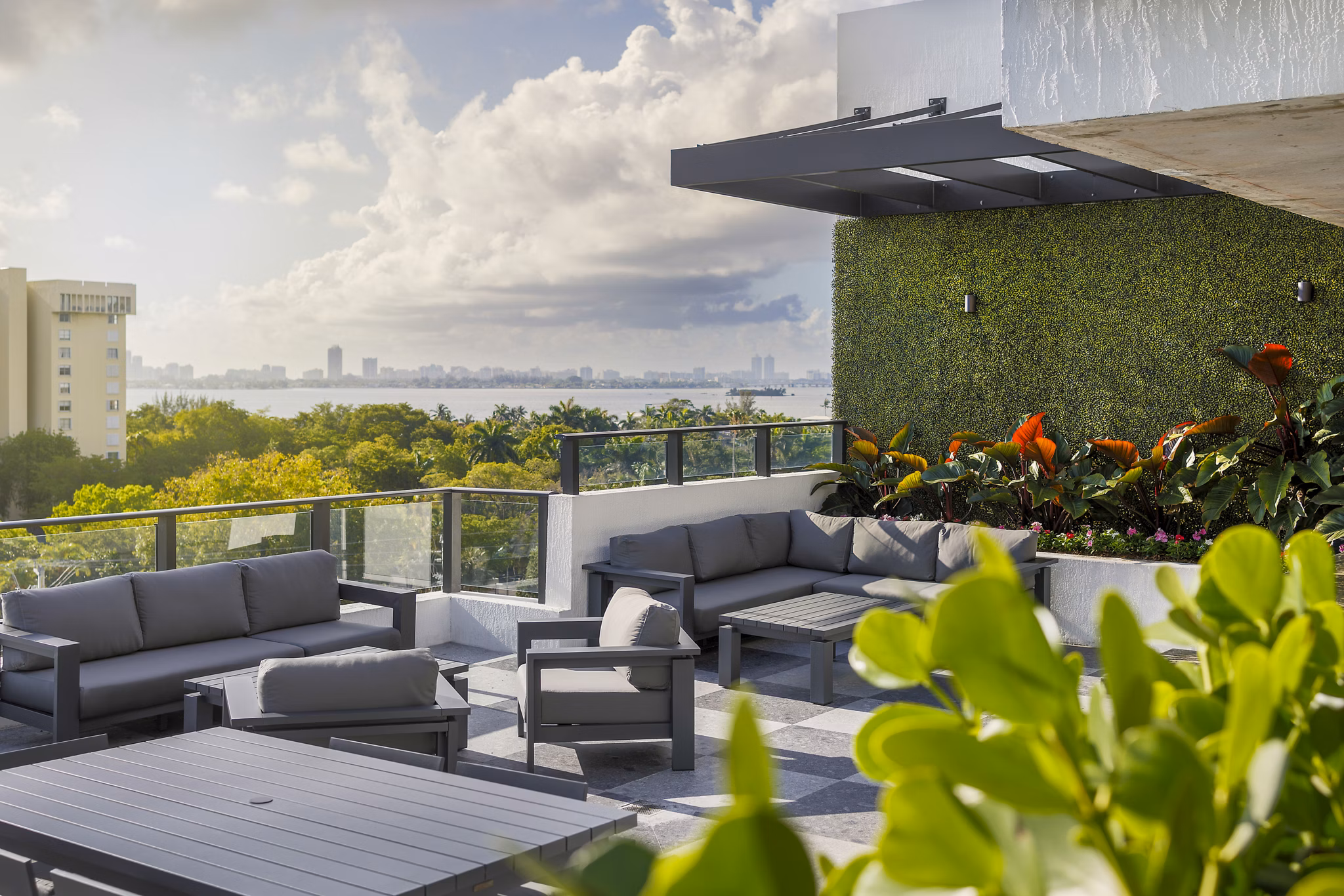 Biscayne 112 Apartments: Stylish patio with modern furniture and lush greenery