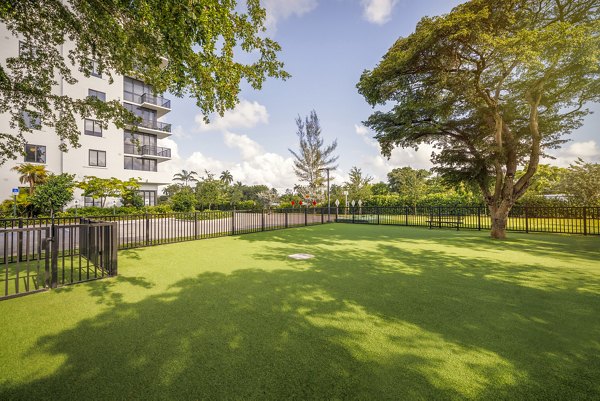 Dog-friendly outdoor area dog park at Biscayne 112 Apartments offering play spaces and agility equipment for residents' pets