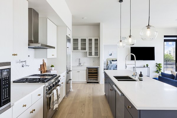 Modern kitchen with sleek countertops and stainless steel appliances in LakeHaus apartments, Minneapolis